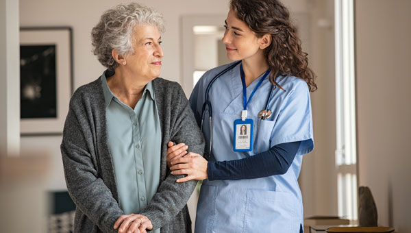 smiling older woman next to clinician